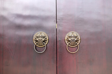 The lion-shaped door cymbals with animal faces on the gates of traditional Chinese architecture
