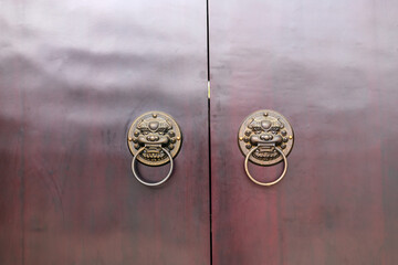 The lion-shaped door cymbals with animal faces on the gates of traditional Chinese architecture