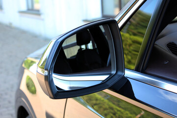 Look in the rear view mirror of a car. Side rear-view mirror. View of the outside rearview mirror...