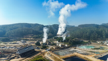 Aerial drone sight of an industrial smoke from a pulp and paper mill, focusing on chimney and boiler emissions, symbolizing environmental and climate concerns