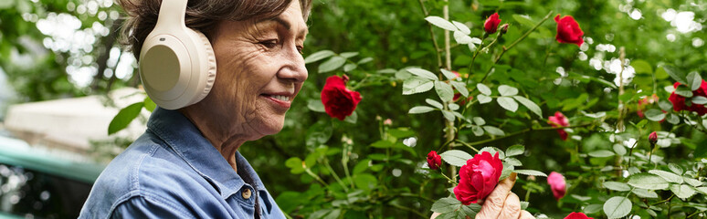 Enjoying the beauty of roses while listening to music in a lush garden setting