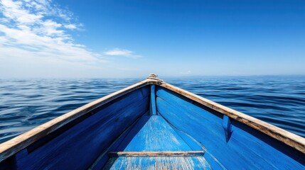 Blue wooden boat on tranquil water, looking out to a clear sky