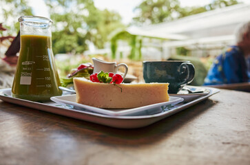 Tray of food with a green container on the left