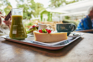 Tray of food with a slice of cake and a glass of juice