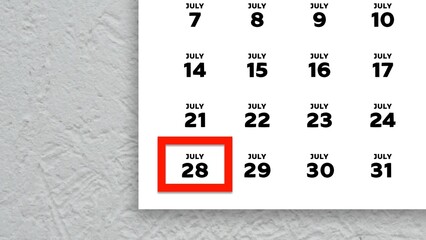 Close-up of the date July 28th marked with a red cursor on the wall calendar 2025