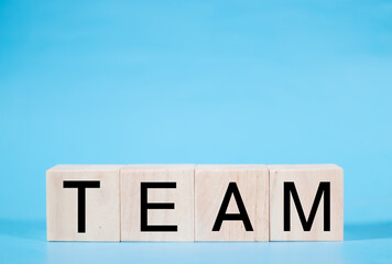 Word team on wooden block, relationship of collaboration and leadership for success, group of community and employee with corporate, teamwork for brainstorming together, no people, business concepts.