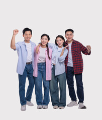 Obraz premium Enthusiastic group of friends celebrate posing together in casual outfits against a plain background