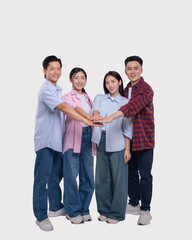 Obraz premium Diverse team of young adults stacking hands in unity symbolizing collaboration and support