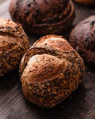The variety includes multigrain, whole wheat, and chocolate-flavored sourdough bread with rustic, crusty textures. Perfect for bakery promotions, food blogs, or culinary editorials showcasing traditio