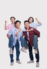 Obraz premium Two friends piggybacking their partners celebrating and smiling demonstrating support and joy