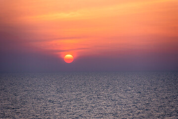 Beautiful vibrant sunset sky over a calm ocean.