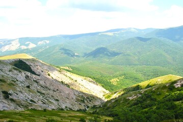 Naklejka premium Beautiful mountain landscape featuring verdant hills and a clear blue sky. Crimea, Ukraine