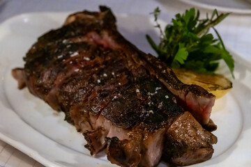 Medium rare meat steak on wooden plate