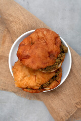 vetkoek and curry mince on rustic surface and copy space