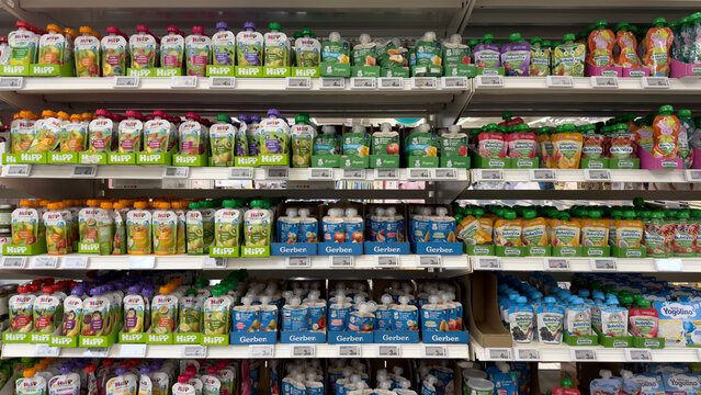 Warsaw, Poland - June 28, 2025: Colorful baby food pouches arranged neatly on supermarket shelves with copy space