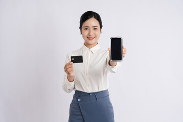 Naklejka premium Smiling woman holding out smartphone and card Online payment secure transaction concept
