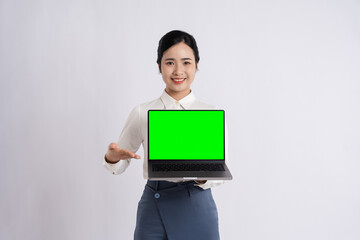 Professional presents laptop with green screen against a plain background ready for content