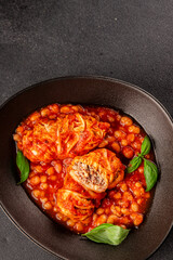 Stuffed cabbage tomato sauce with beans meat, cabbage, fresh delicious gourmet food background on the table rustic food top view copy space