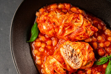 Stuffed cabbage tomato sauce with beans meat, cabbage, fresh delicious gourmet food background on the table rustic food top view copy space