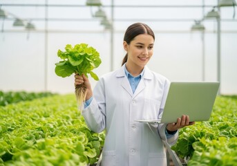 Woman in white lab coat holds lettuce with roots in greenhouse with laptop scientist researcher