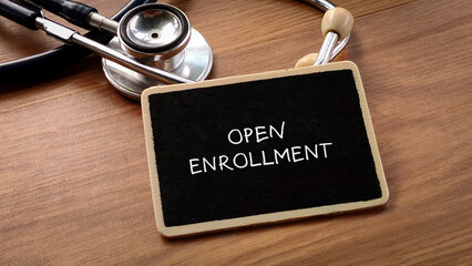 Open Enrollment Concept with Stethoscope and Blackboard
