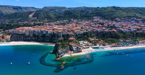 Breathtaking aerial view of Tropea, a charming town perched on a cliff overlooking the turquoise...