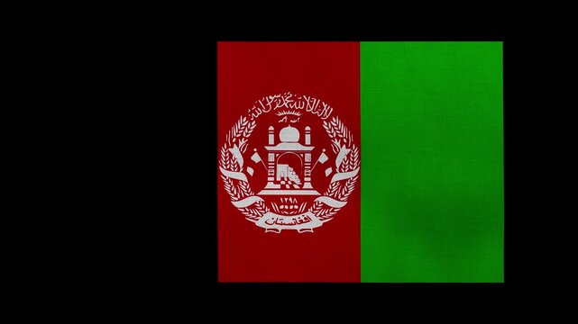 An Afghanistan flag rolls and waves in front of a black background.