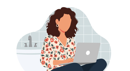 A woman with curly hair works on her laptop in a modern bathroom, enjoying a comfortable remote work setup.