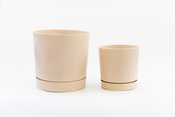 Modern minimalist plant pots displayed in a bright studio environment with soft lighting