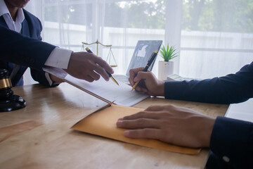 Lawyer at desk in office with legal documents and hammer, giving advice on justice, contracts,...