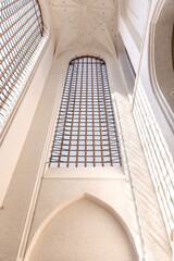 Bright Gothic vaults. Soft light in church. Modern minimalism of antiquity