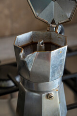 Macro detail of the inside of an empty italian moka pot before brewing. Close-up on the filter and...