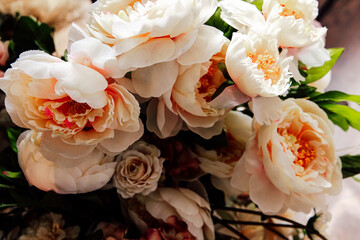 Beautiful bouquet of white peonies with soft pink accents arranged elegantly in a floral display