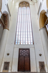 Gothic window. Stained glass. Wooden doors