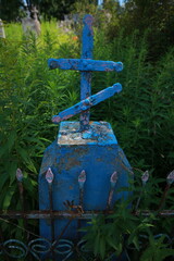 old cracked cross gravestone in cemetery
