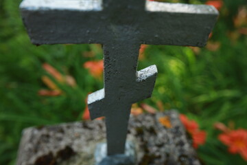 old cracked cross gravestone in cemetery