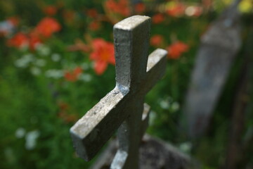 old cracked cross gravestone in cemetery