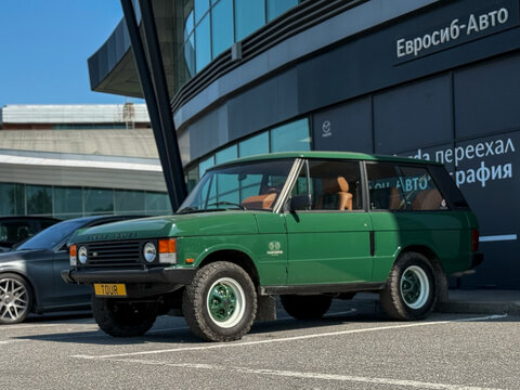 Classic Range Rover I-generation green color 1970 &ndash; 1994 on parking lot. Classic I generation Land Rover Range Rover Classic luxury off-road vehicle. Retro car. 