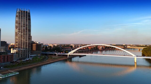 High-rise building near the arched bridge. Footage above the Danube with the view on the Appolo Bridge in Bratislava, Slovakia.