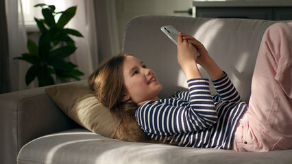Little girl holding mobile phone smartphone communication connection video call talking chatting...