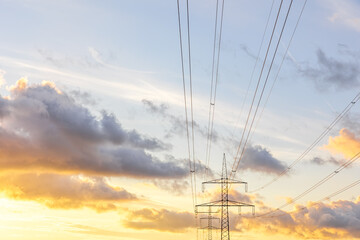 Power lines at sunset. Modern electricity. Nature innovation