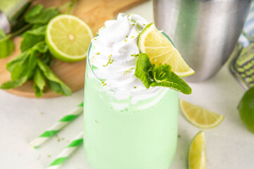 Key lime pie or mojito taste cold milkshake cocktail. Sweet sour dessert creamy drink with whipped...