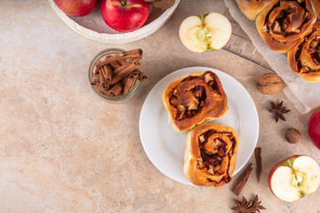 Apple cinnamon roll, sweet cinnabon buns with apple filling. Viral apple pie rolled buns, on beige...