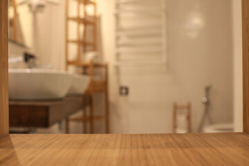 Empty bamboo shelf surface in focus with blurred modern bathroom background. Cozy spa interior with...