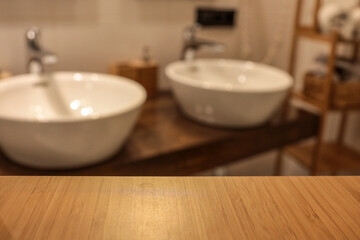 Empty bamboo shelf surface in focus with blurred modern bathroom background. Cozy spa interior with...