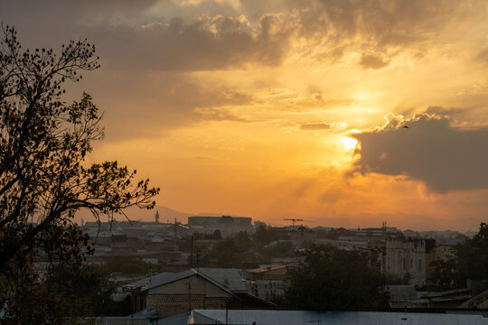 Sunrise over the roofs of Samarkand with a coudy sky