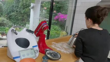 Skilled home baker whisking ingredients with modern stand mixer in sunlit, clean kitchen, crafting artisanal recipe with precision and passion