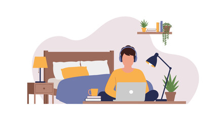 A young man with headphones sits in front of his bed, working on a laptop in a relaxed home environment, indicating remote work or online learning.