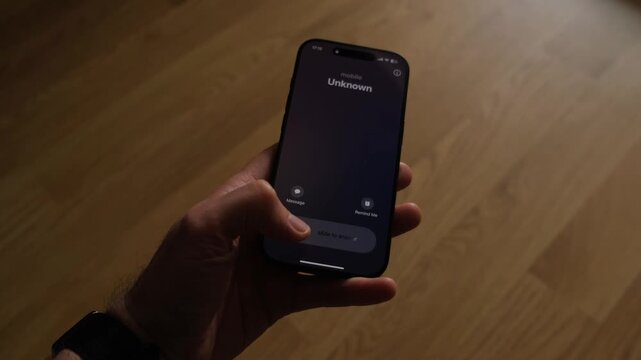 Fraud or fraudulent schemes. Close-up of a male hand holding a phone with an unexpected incoming call from an unknown