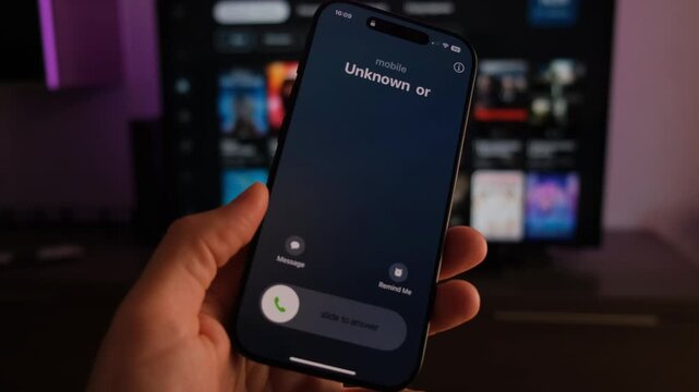 Fraud or fraudulent schemes. Close-up of a male hand holding a phone with an unexpected incoming call from an unknown